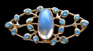 Jessie M King brooch design for Liberty & Co. Gold, moonstone and enamel. Liberty model number 1800. Sold by Tadema Gallery.