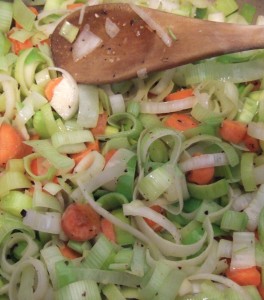 Sweating the leeks and carrots in butter, with salt and freshly ground black pepper.