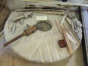 Millstone with tools to dress it when it had worn down too much.