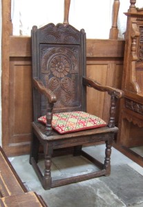 A beautiful Jacobean carved oak chair near the altar.