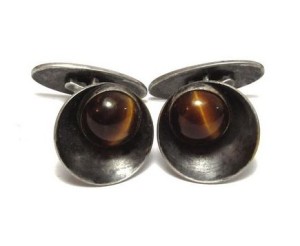 N E From tiger's eye cufflinks.