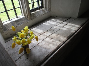 Daffodils and tulips in one of the windows.