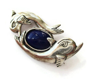 Vintage sterling silver and blue glass dolphin brooch. For sale in my Etsy shop: click on photo for details.
