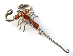 Art Deco scorpion brooch with glass jewels.