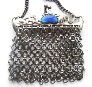 Vintage mesh metal purse with dragon design and blue cabochons.