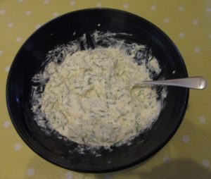 Grated cheddar, soured cream, spring onions and chives.